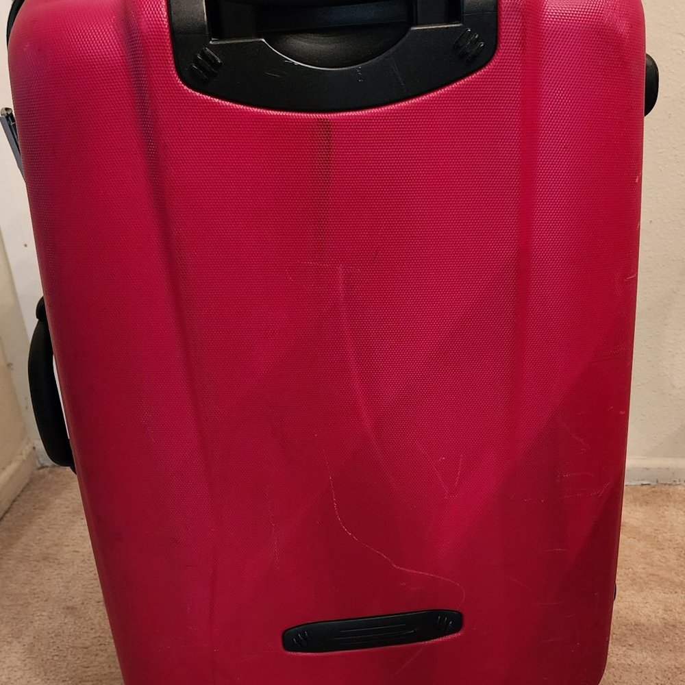 Large red Delsey suitcase